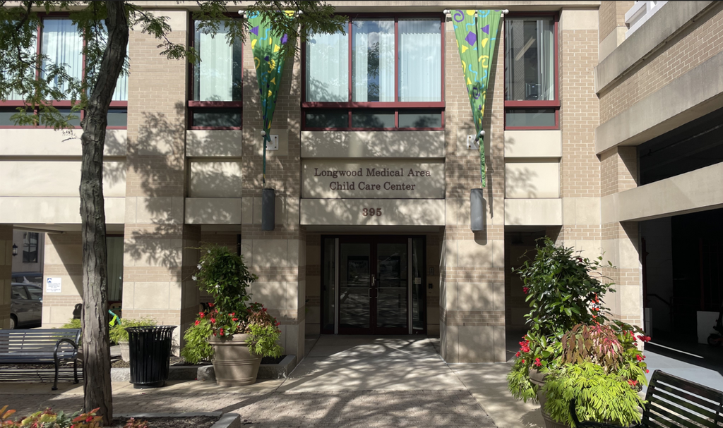 photo of the exterior of the LMACCC, showing the front door with greenery